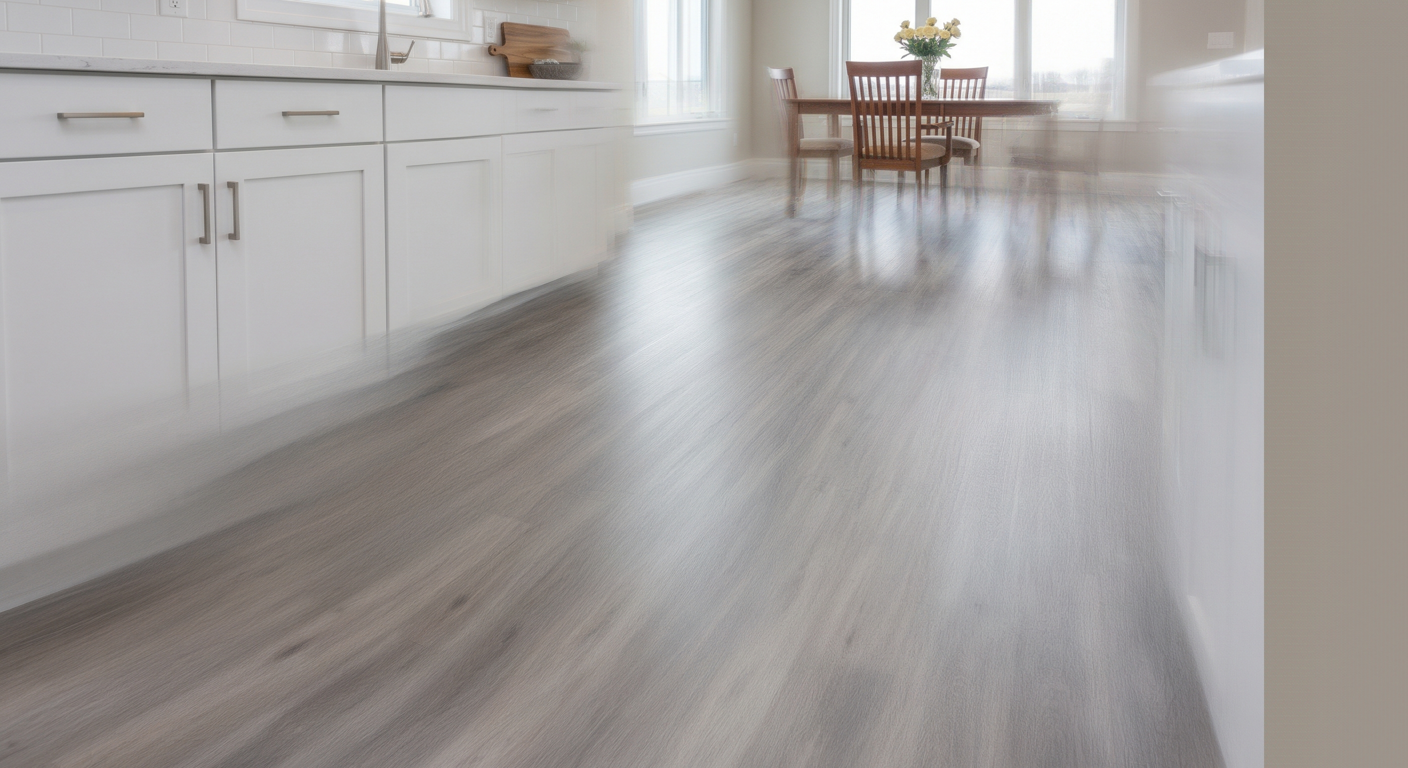 Modern gray wood-look flooring in a bright kitchen